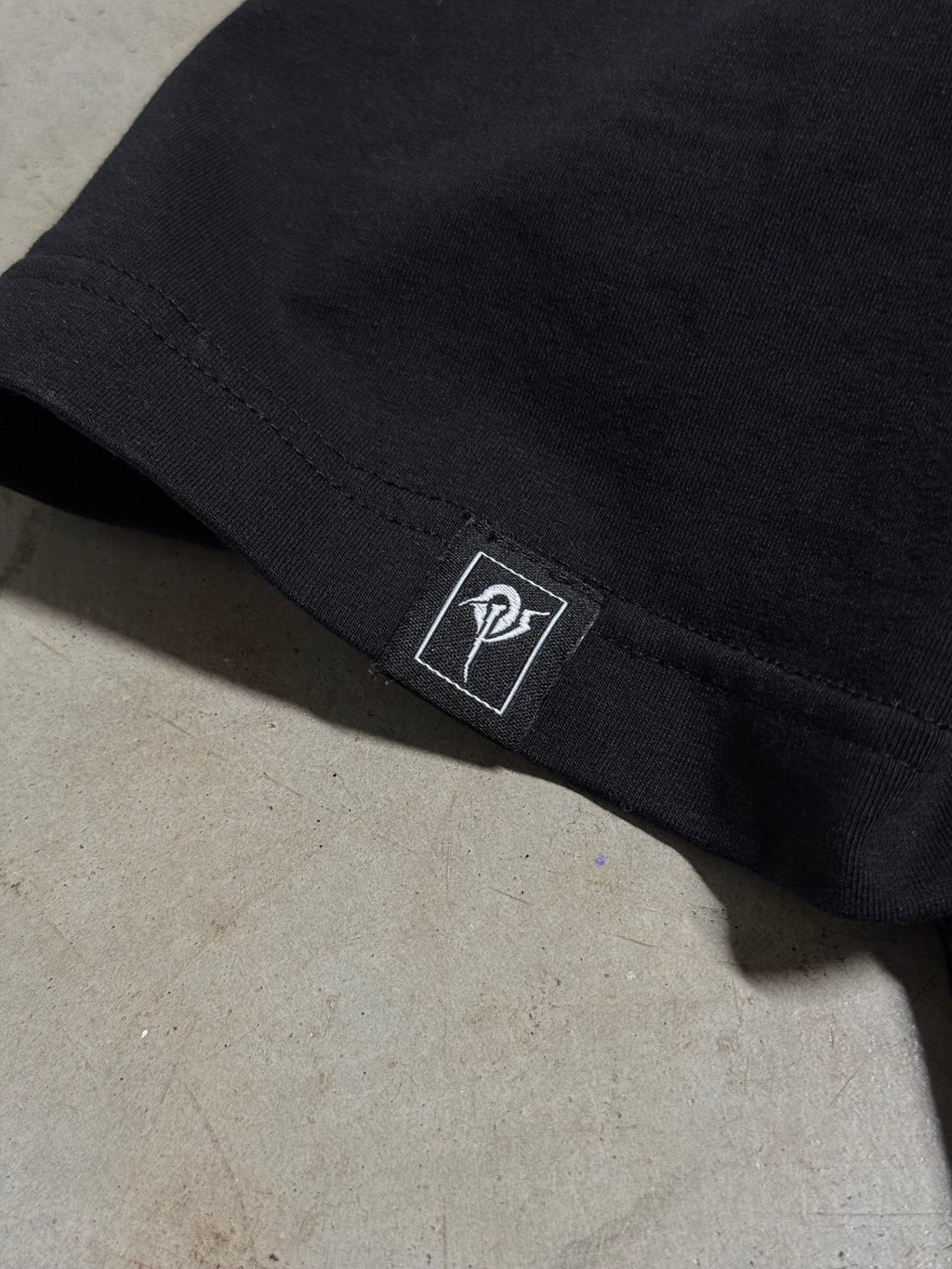Small OP patch on the sleeve hem of the OverPower oversized tee