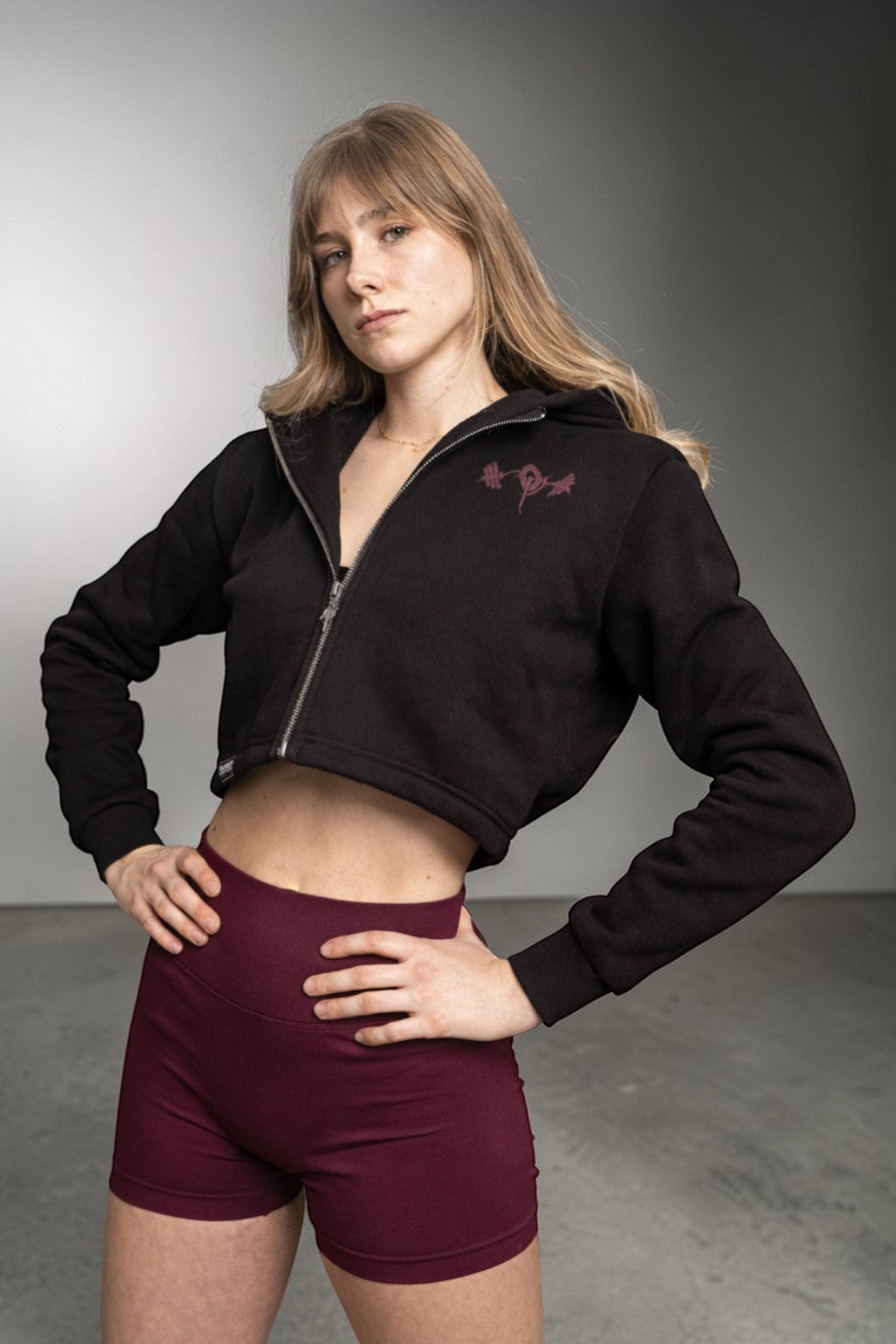 OverPower Strength Wear black cotton fleece crop zip-up hoodie with graphic detail and metal zipper.