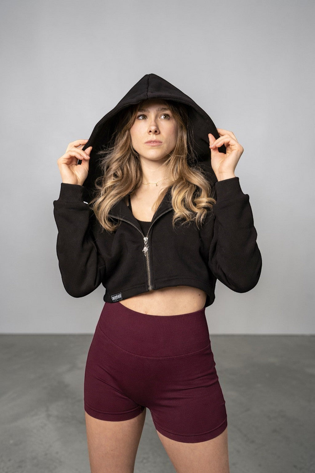 OverPower Strength Wear black cotton fleece crop zip-up hoodie with custom metal zipper and hood.