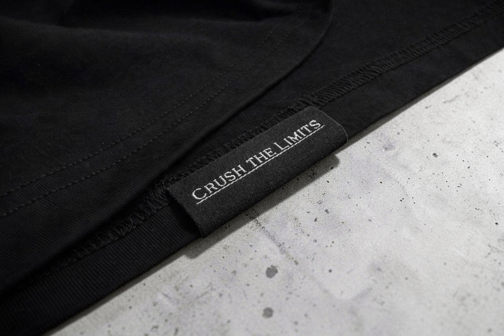 OverPower Strength Wear black oversized cotton blend t-shirt with "Crush the Limits" tag.