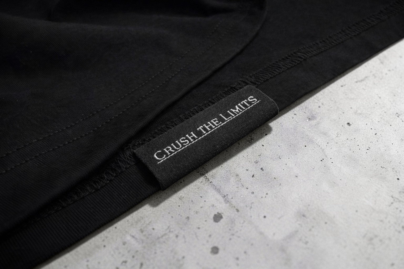 OverPower Strength Wear black oversized cotton blend t-shirt with "Crush the Limits" tag.