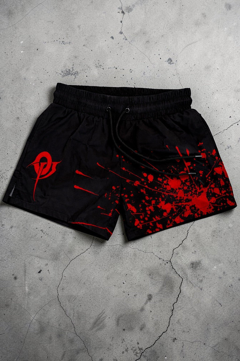 OverPower Strength Wear black unisex MMA shorts with red blood splatter graphic and logo. Nylon/spandex blend.