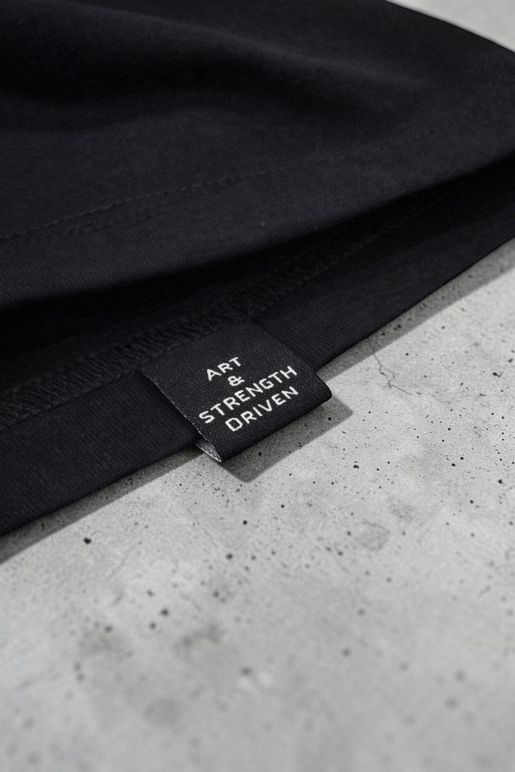 OverPower Strength Wear Black Widow oversized tee, premium heavyweight cotton with "ART & STRENGTH DRIVEN" label.