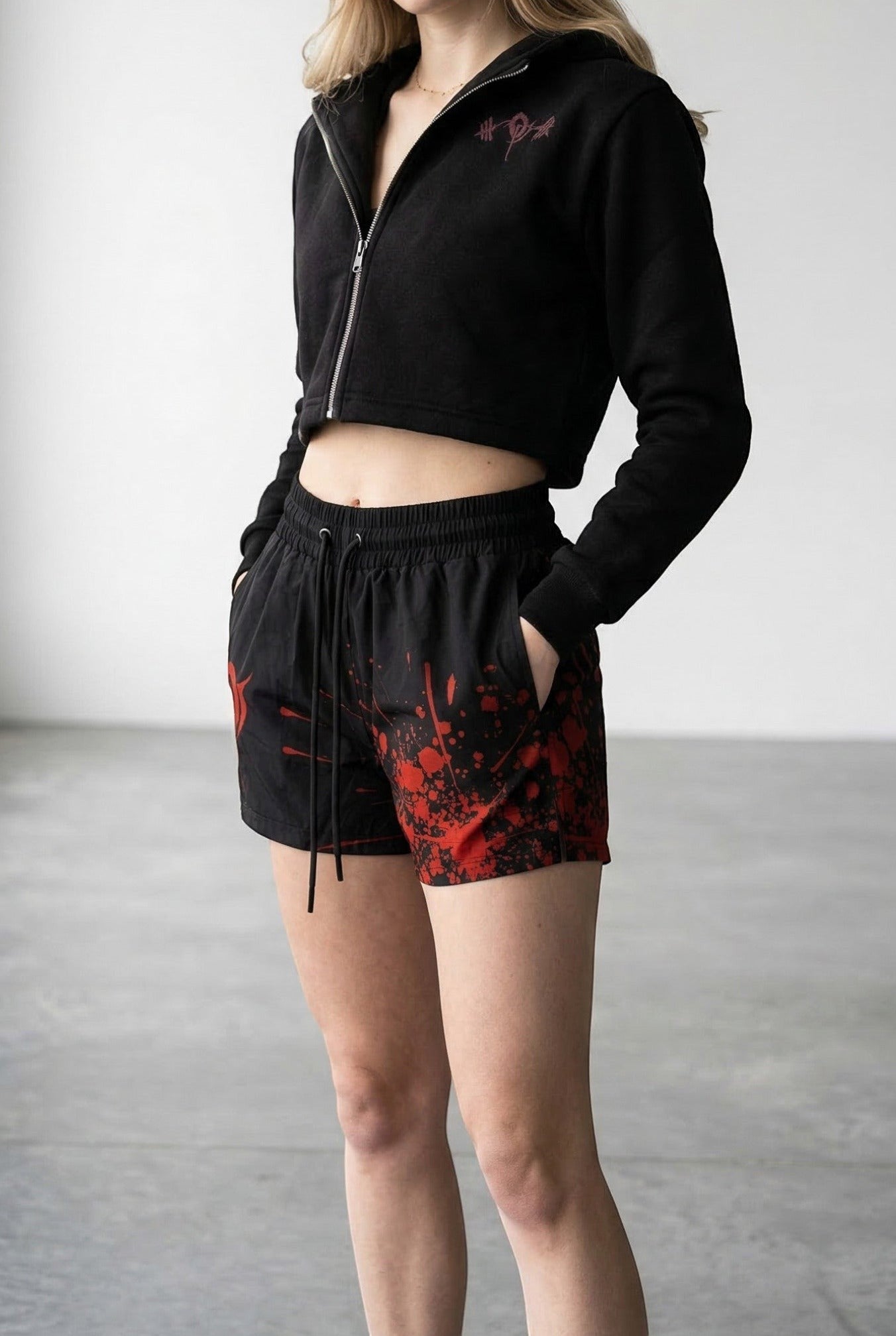 OverPower Strength Wear unisex black shorts with red blood splatter graphic, nylon/spandex blend, drawstring waist.