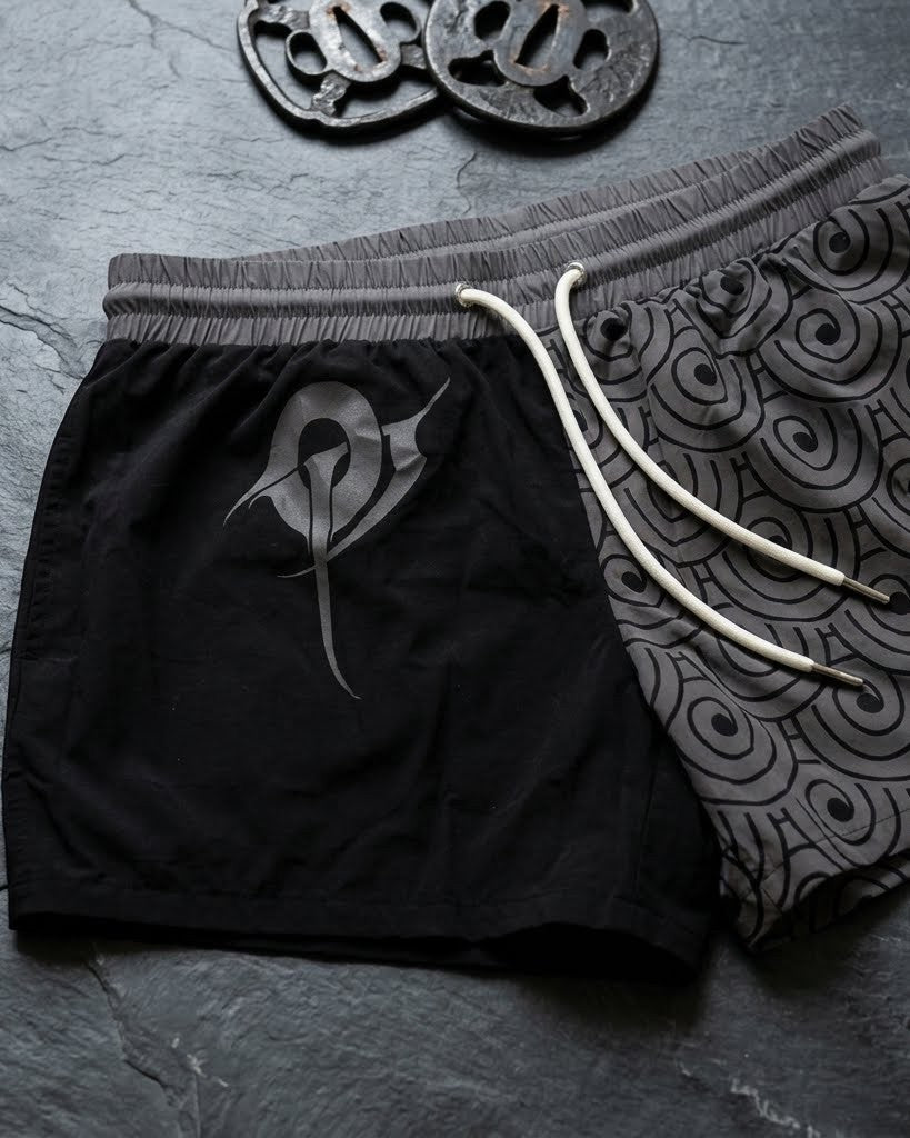 OverPower Strength Wear unisex black and grey shorts with Japanese Bushido graphic and wave pattern. Nylon/spandex blend.