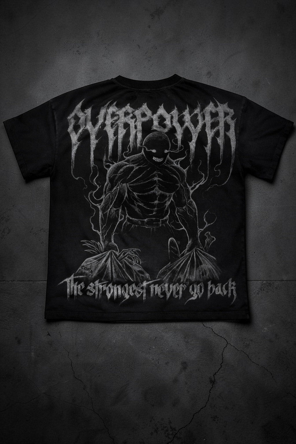 OverPower Strength Wear black oversized cotton blend tee with a death metal creature graphic and "The strongest never go back" text.